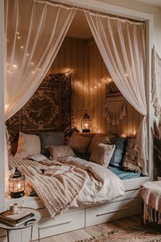 a bed with white curtains and lights on the headboard