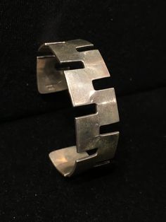 "Old Mexican Sterling Silver abstract modern cuff bracelet with attractive MCM style sculptural cut out design. Mexico & 925 stamps 13/16\" wide 5.75\" interior circumference plus 1 3/8\" flexibile gap 37g 505R - This stunning piece is coming from an exciting relationship with a well known & popular Santa Fe, NM, jewelry gallery. I will be listing many exquisite pieces, some at lower prices than they are offered at in the gallery! The owner is a certified Gemologist who has been dealing Modernist Cuff Bracelet With Polished Finish, Modernist Polished Cuff Bracelet, Modernist Sterling Silver Bangle, Contemporary Sterling Silver Bangle Bracelet, Contemporary Adjustable Sterling Silver Bracelet, Modernist Sterling Silver Bracelet, Modern Sterling Silver Cuff Bracelet, Adjustable Modernist Sterling Silver Bracelet, Old Mexico