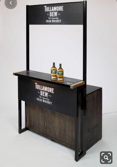 a display case with two bottles on it and a sign that says tullamore dew