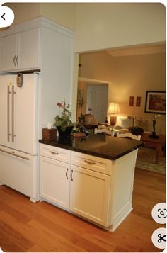 a white refrigerator freezer sitting inside of a kitchen next to a counter top oven