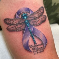 a dragonfly with a purple ribbon on it's leg is shown in this tattoo design