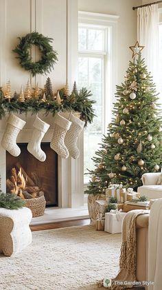 a living room decorated for christmas with stockings hanging from the mantel, fireplace and tree