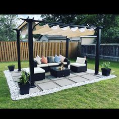 an outdoor living area with couches and tables