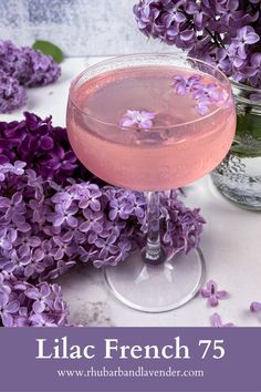 lilac french 75 cocktail in a glass with purple flowers