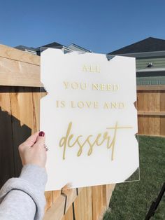 someone holding up a sign that says, all you need is love and dessert