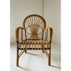 a chair made out of rattan and wicker sitting on top of a white floor