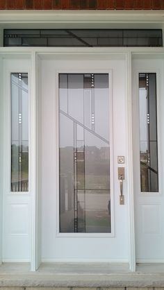 a white front door with glass panels on it