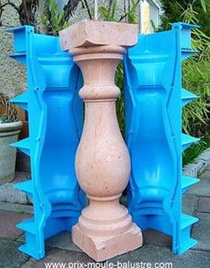 two blue vases sitting next to each other in front of some plants and bushes