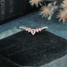 an image of a ring with three hearts on it sitting on a black velvet box