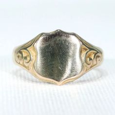 I know class rings are a thing, and I'm in no way opposed, but when the young men in my family graduate from college, I give them a ring just like this one. There is something about a ring like this one that makes young men look, well, manly. Do you know an upcoming graduate? Send him out into the world right, with a bespoke suit, a pair of well made wingtips and a ring like this. This wonderful Edwardian version of the signet ring was hand crafted in Birmingham, England in 1915. The top is a sh Heirloom Engraved Round Band Rings, Classic Yellow Gold Signet Ring With Maker's Mark, Classic Yellow Gold Engraved Ring With Maker's Mark, Concave Signet Ring With Polished Finish For Anniversary, Classic Engraved Yellow Gold Ring With Maker's Mark, Victorian Silver 14k Gold Signet Ring, Victorian Silver Signet Ring In 14k Gold, Victorian Engraved Signet Promise Ring, Victorian Rings With Engraving Option For Anniversary