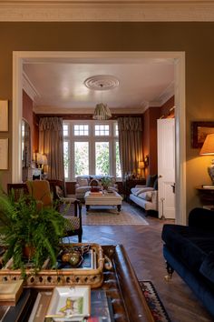 a living room filled with furniture and lots of windows