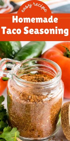 homemade taco seasoning in a glass jar next to tomatoes and cilantro