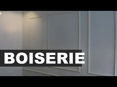 there is a sign that says boiserie in front of a mirror and light fixture