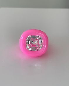 a pink object sitting on top of a white table