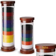 three glass containers with different colors and sizes on them, one is brown the other is white