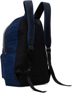 Non-stretch denim backpack in blue. · Buffed leather trim throughout · Webbing carry handle · Adjustable padded shoulder straps · Logo embossed at face · Zip pocket at face · Padded mesh panel at back face · Two-way zip closure · Laptop compartment · Twill lining · H18 x W14 x D5 Supplier color: Blue Juun J, Denim Backpack, Mesh Panel, Leather Trim, Leather Trims, Stretch Denim, Shoulder Straps, Carry On, Blue Denim