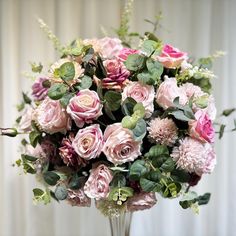 a vase filled with lots of pink flowers