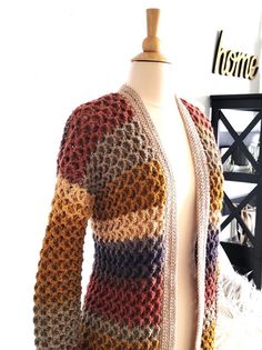 a mannequin wearing a multicolored knitted cardigan