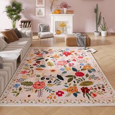 a living room filled with furniture and flowers on the rug