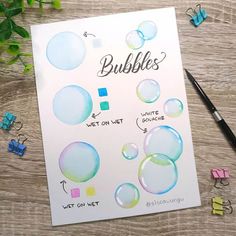 a sheet of paper with bubbles on it next to some markers and pencils nearby