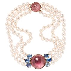 Composed of three strands of cultured pearls suspending a luscious cabochon pink tourmaline flanked by sapphires and diamonds, this ladylike choker casts a luminous glow on the skin. The thoughtful design terminates in a carved pink tourmaline clasp. Internal circumference is approximately 15.25” Pearls measure approximately 8.4 to 8.9 mm Signed Seaman Schepps White Coral Necklace, Victorian Choker Necklace, Seaman Schepps, Necklaces Choker, Vintage Choker Necklace, Cognac Diamonds, Pearl And Diamond Necklace, Vintage Choker, Diamond Jewelry Necklace