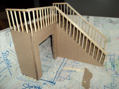 a cardboard model of a staircase on top of construction paper