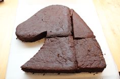 a piece of chocolate cake sitting on top of a white cutting board