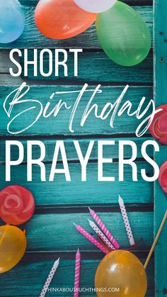 the words short birthday prayer are surrounded by balloons and lollipops on a blue wooden background