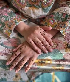 a woman's hands with tattoos on them