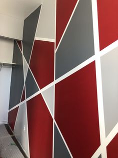 a room with red, grey and white walls