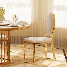 a dining room table with two chairs and a vase on top of it next to a window