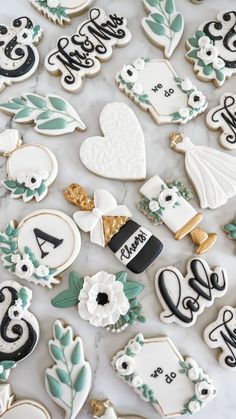 decorated wedding cookies are laid out on a table