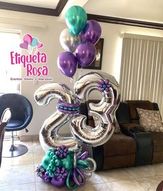 balloons are in the shape of the number twenty eight and flowers on top of each balloon