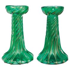 two green glass vases sitting next to each other