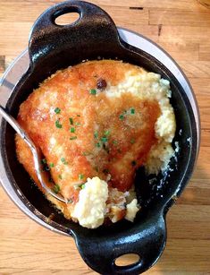 a chicken dish with mashed potatoes and parsley in a cast iron skillet