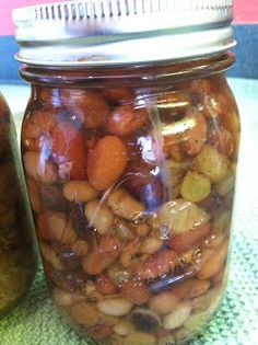 two jars filled with food sitting on top of a table