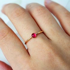 A simple 14k gold-filled or sterling silver band encrusted with your choice of birthstone Ruby gemstone in the center! ∙ Gift Ready in a jewelry box! ∙ Handmade in Vancouver, Canada.  ∙ 100% 14k Gold Fill or Sterling Silver ∙ Rings Sold Individually Please note: All stones due to its nature will vary in colour, flash and hue! --------------------------------- M E A S U R E M E N T :  Width: 1.25mm  Gemstone: 4mm  Size: Optional (US measurement) If your ring size is not specified as an option, pl 14k Gold Filled Gemstone Rings For Gift, Everyday Crystal Ring With Birthstone, Everyday Rose Gold Round Birthstone Ring, Adjustable Solitaire Birthstone Ring For Gift, Gift Gemstone Rings In 14k Gold Filled, Adjustable Solitaire Birthstone Ring For Everyday, Minimalist Ruby Ring Birthstone, Minimalist Ruby Ring With Birthstone, 14k Gold Stackable Rings With Birthstone