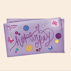 a purple bag with the word neferty written on it and butterflies around it