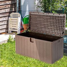 an outdoor storage box sitting in the grass