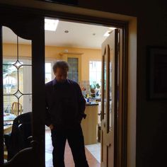 a man standing in the doorway of a house