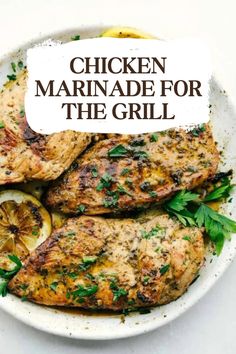 chicken marinade for the grill on a white plate with lemons and parsley