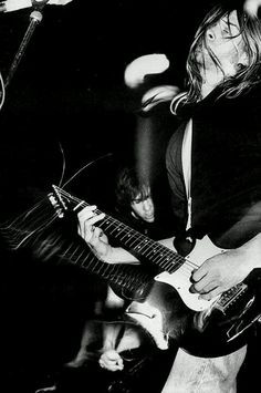 black and white photograph of man playing guitar