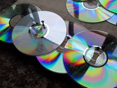 four cd's sitting on top of each other with different colors and sizes in them