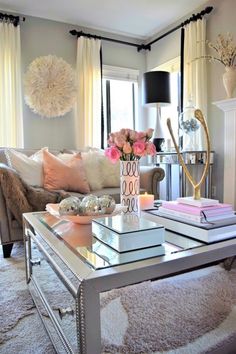 a living room filled with lots of furniture and flowers on top of a coffee table