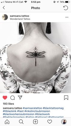 the back of a woman's neck with a dragonfly tattoo on her left shoulder