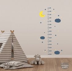 a child's room with a teepee tent, stars and clouds on the wall