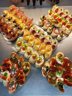 a table topped with lots of different types of appetizers on top of glass plates