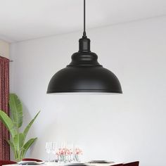 a dining room table and chairs with a black light hanging over it's head