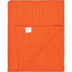 an orange knitted blanket with a tag on it's end and a white background