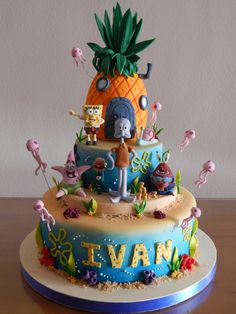 a birthday cake decorated with cartoon characters and pineapple on the top is an island